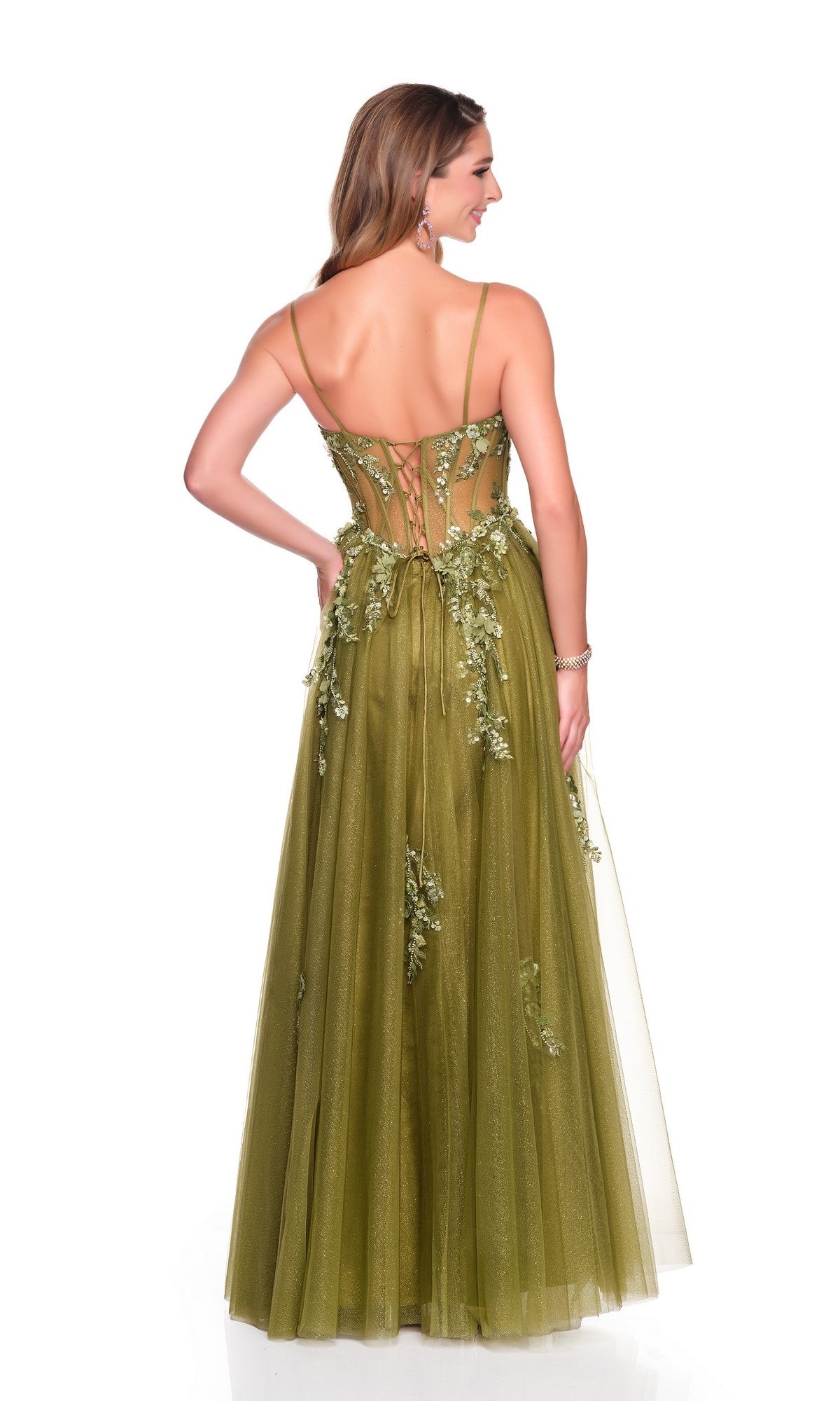 A woman models the Dave and Johnny 12602 long prom dress in olive green, featuring a lace-up open back and floral appliques, exuding sheer elegance as she stands with her back to the camera.